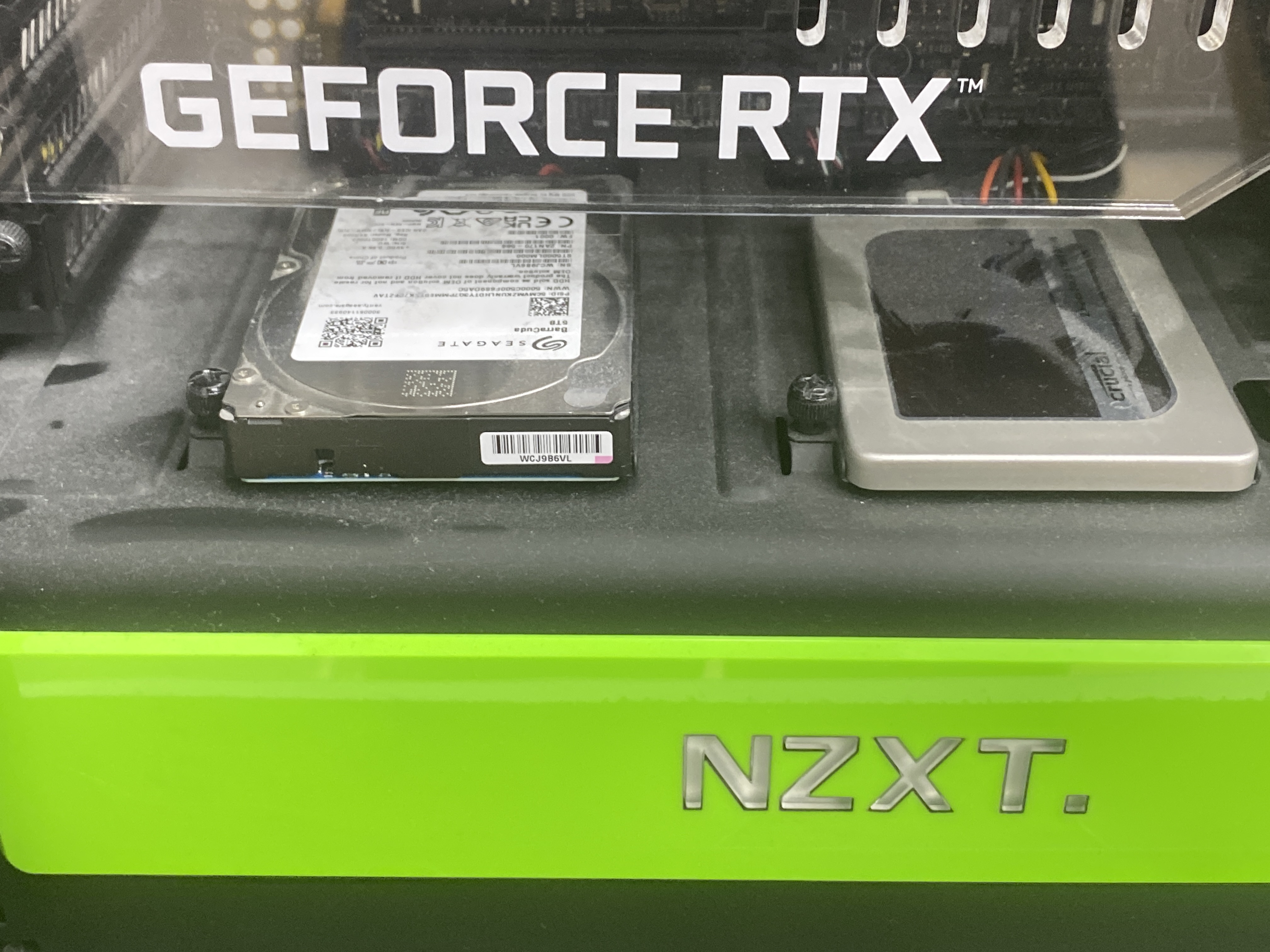 Seagate BarraCuda 3,5″ HDD a Crucial 2,5″ SSD osadené vedľa seba v skrinke NZXT pod grafickou kartou GeForce RTX.
